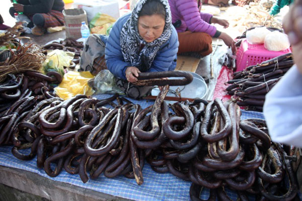 selling blood sausages in a market in Bhutan